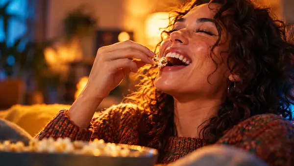 Close-up of a person enjoying a crisp snack, shot with warm cinematic color and playful energy.